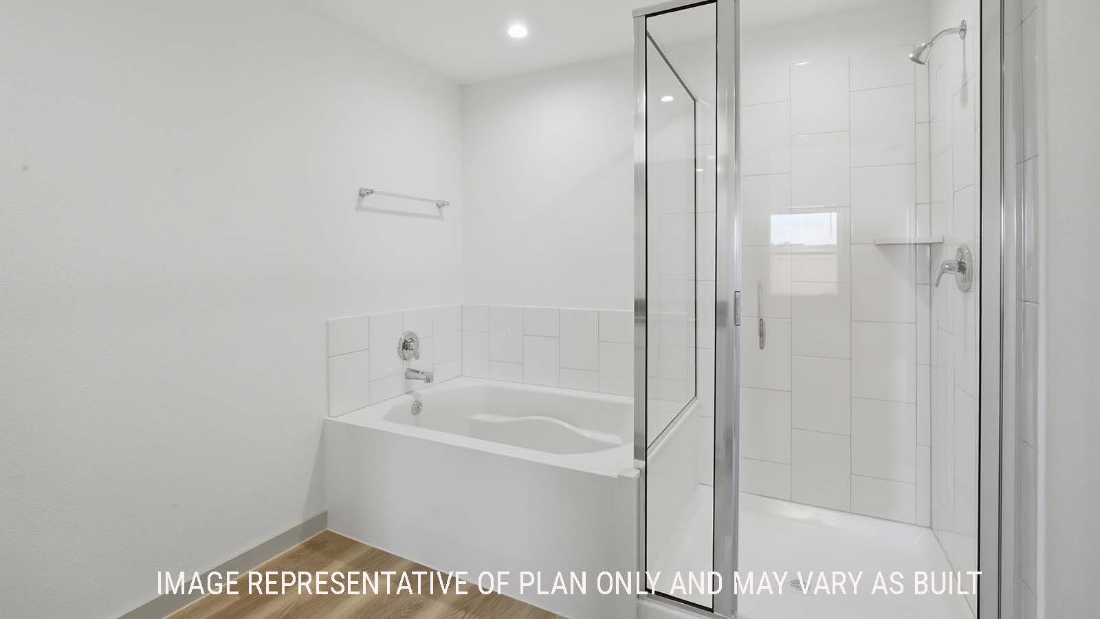 Kingston primary bathroom with vinyl plank flooring and garden tub and walk-in shower.