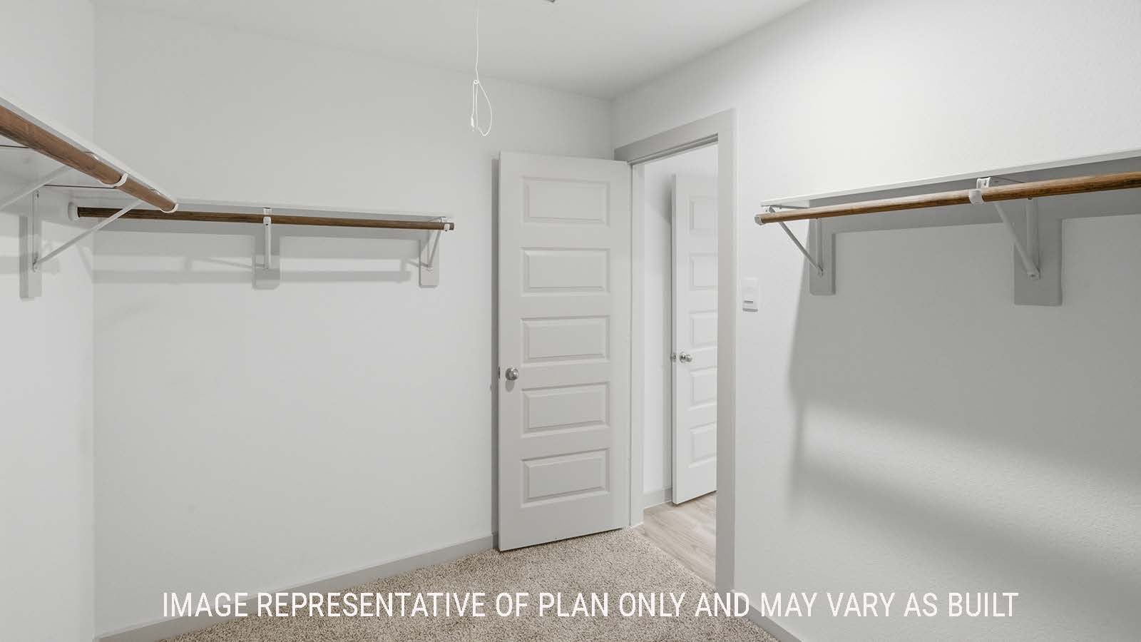 Kingston primary bedroom closet with carpeted flooring and shelving for storage.