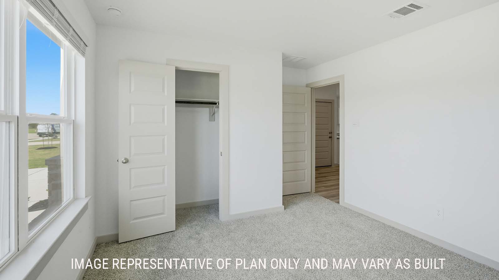 Kingston secondary bedroom with carpeted flooring and window for natural lighting.
