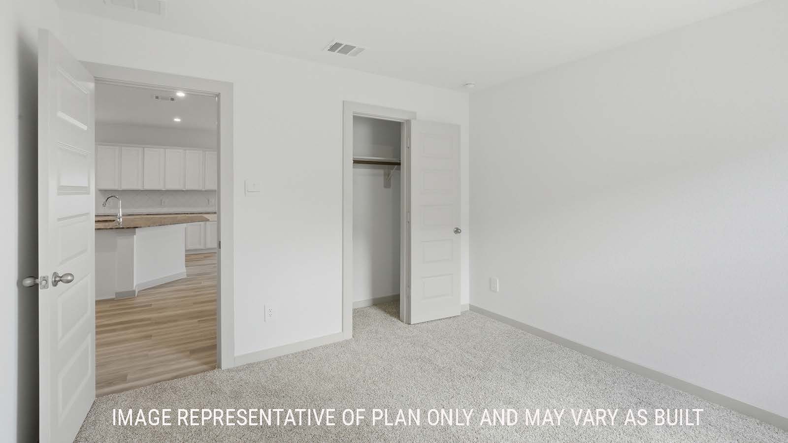 Kingston secondary bedroom with carpeted flooring and view of open concept kitchen.