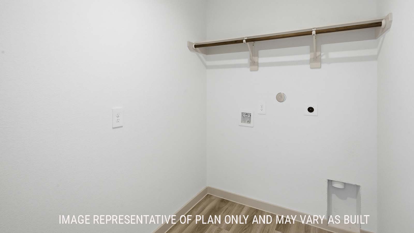 Kingston utility room with washer and dryer connections and shelving for storage.