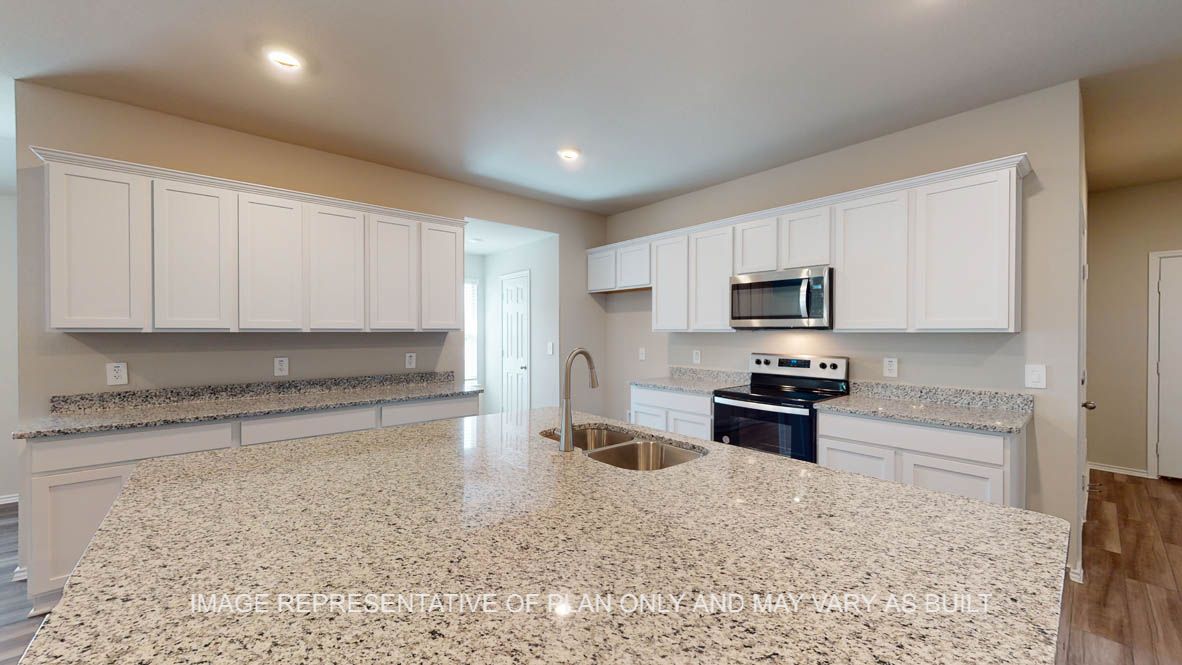 Kingston kitchen with white cabinets and granite countertops.