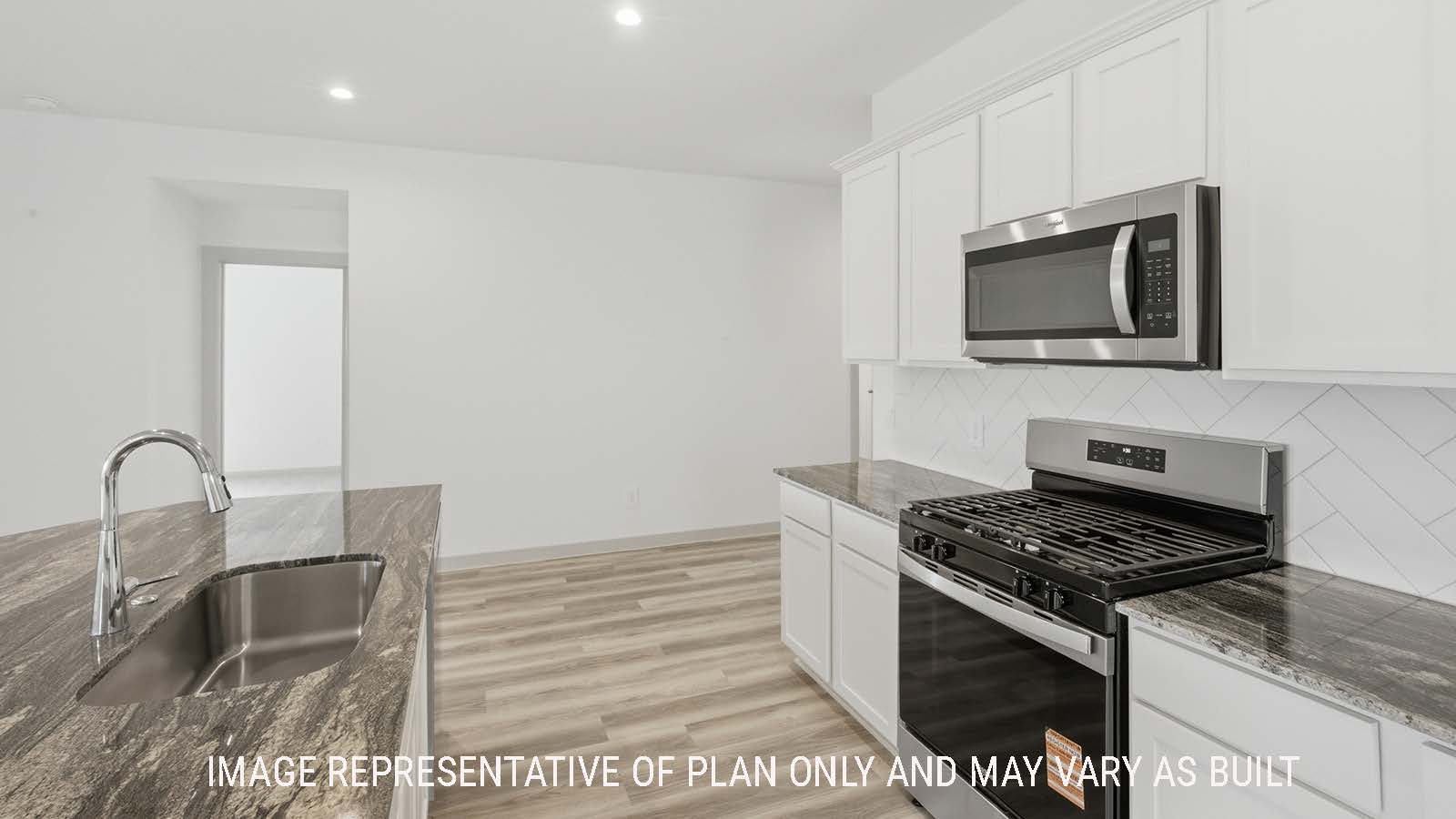 Kingston kitchen with white cabinets and granite countertops with view of secondary bedroom.