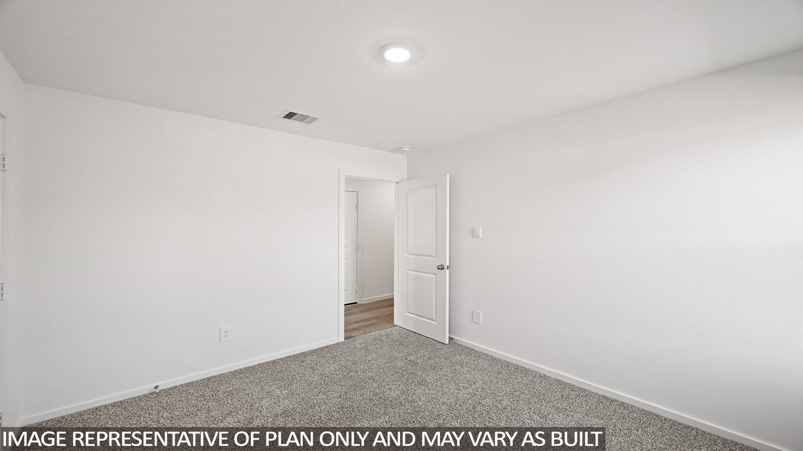 Archer secondary bedroom with carpeted flooring and view of hallway.