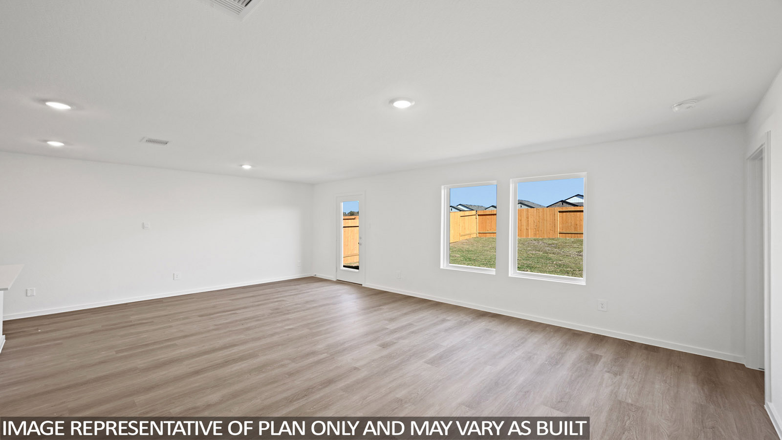 Bradley living room with vinyl plank flooring with view of back door and back yard.