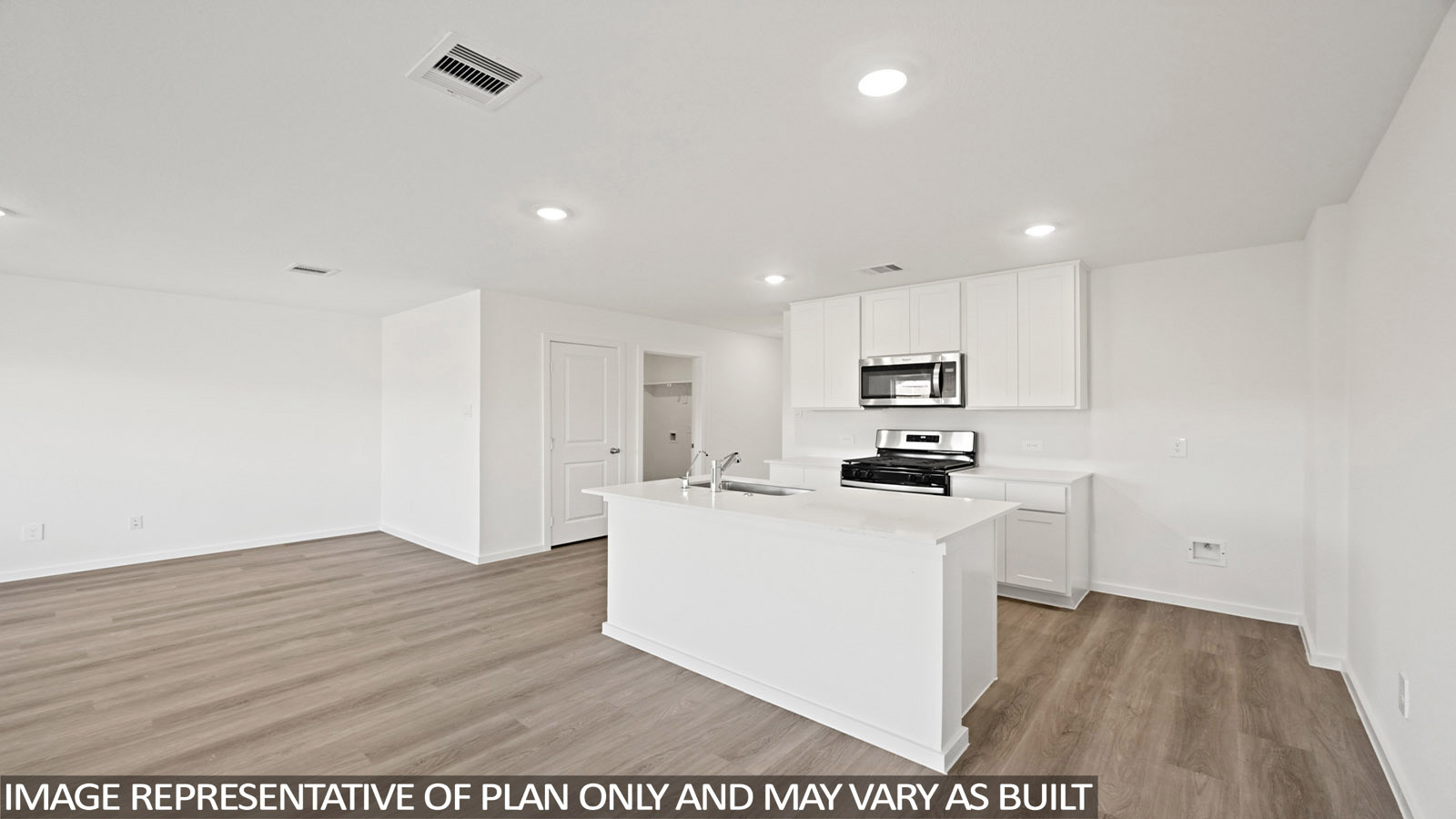 Bradley kitchen with kitchen island with white cabinets and white countertops.