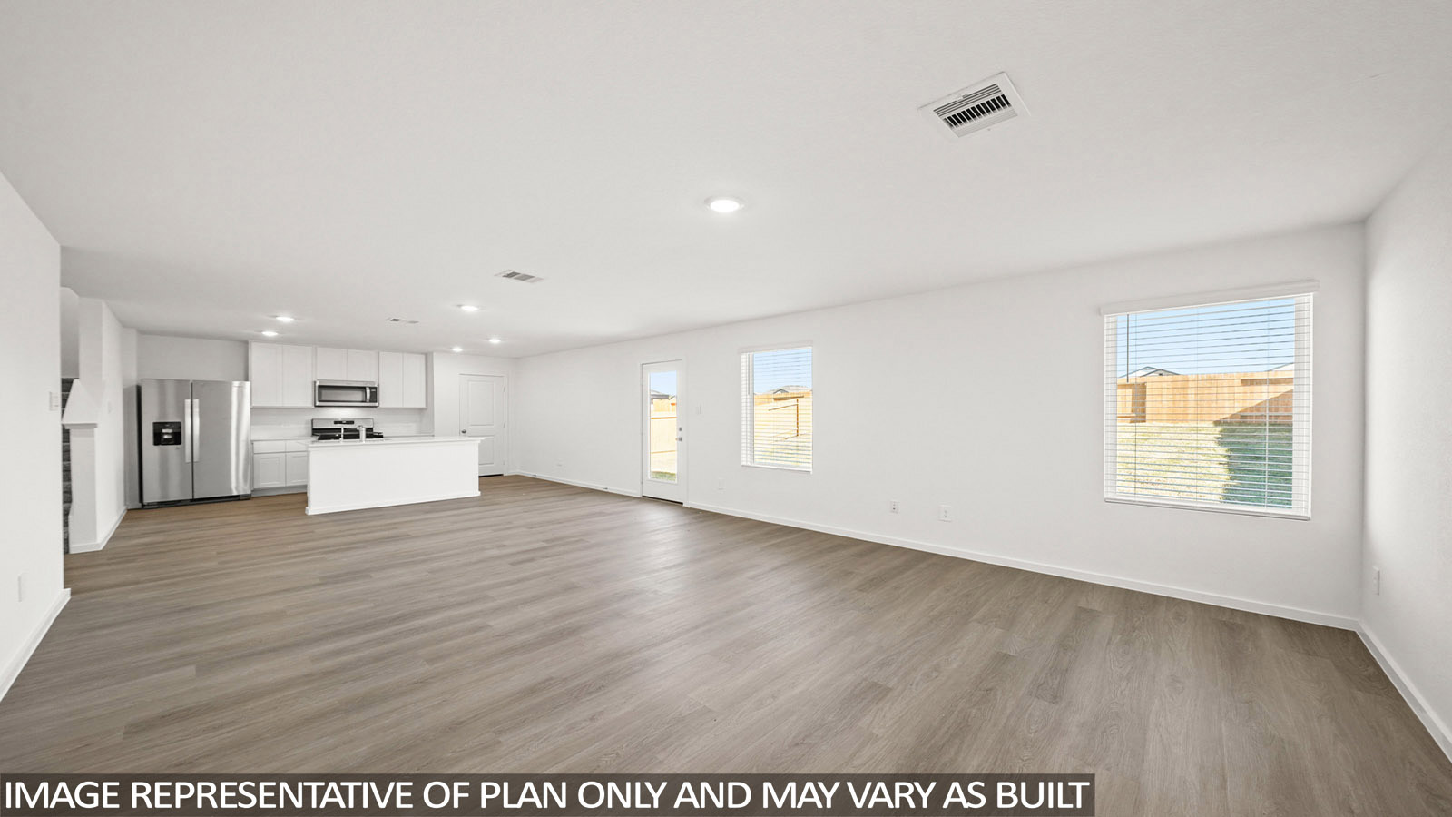 Dawson living room with vinyl plank flooring with view of open-concept dining room and kitchen.