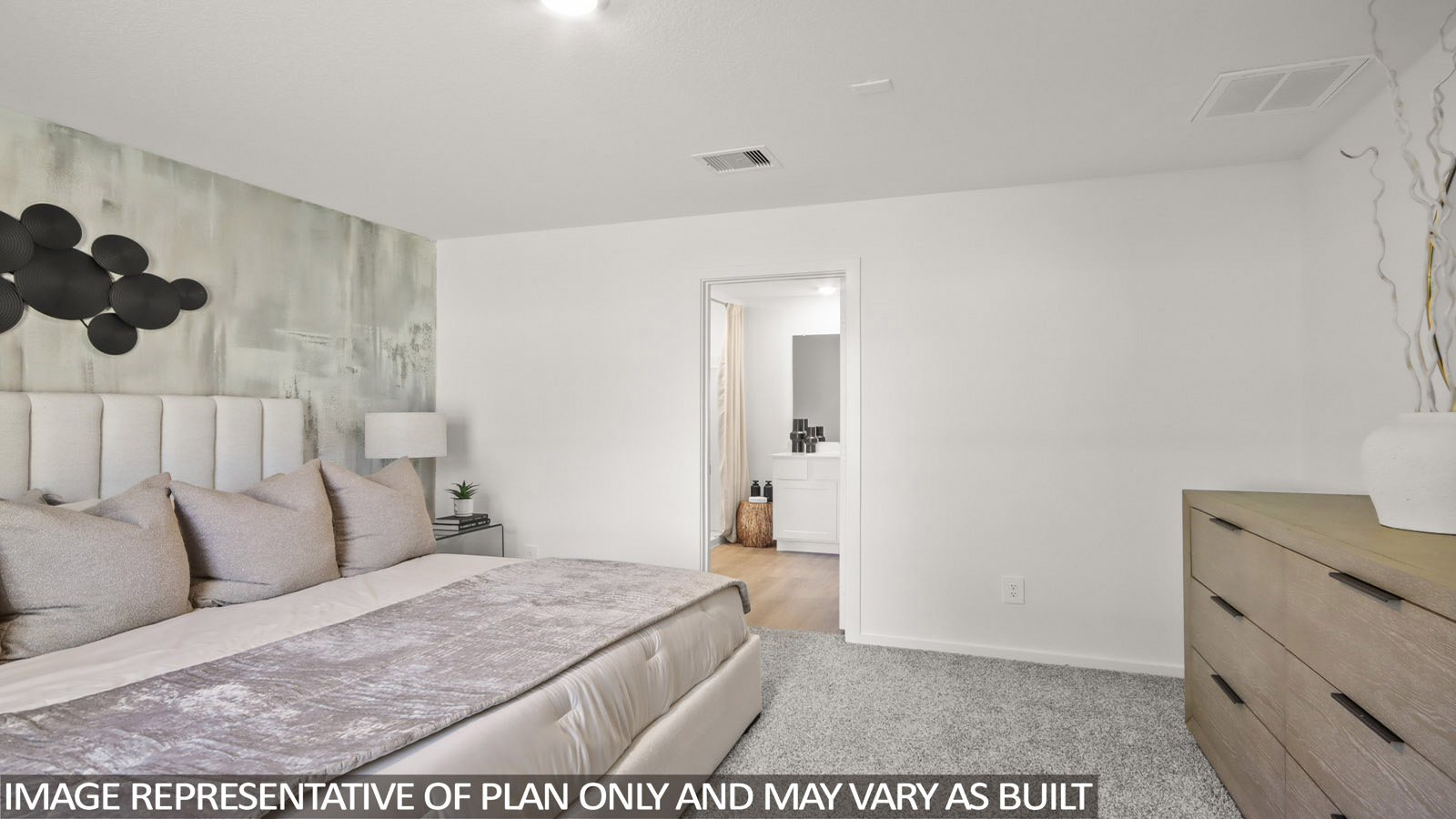 Austin primary bedroom with carpeted flooring and view of primary bathroom.