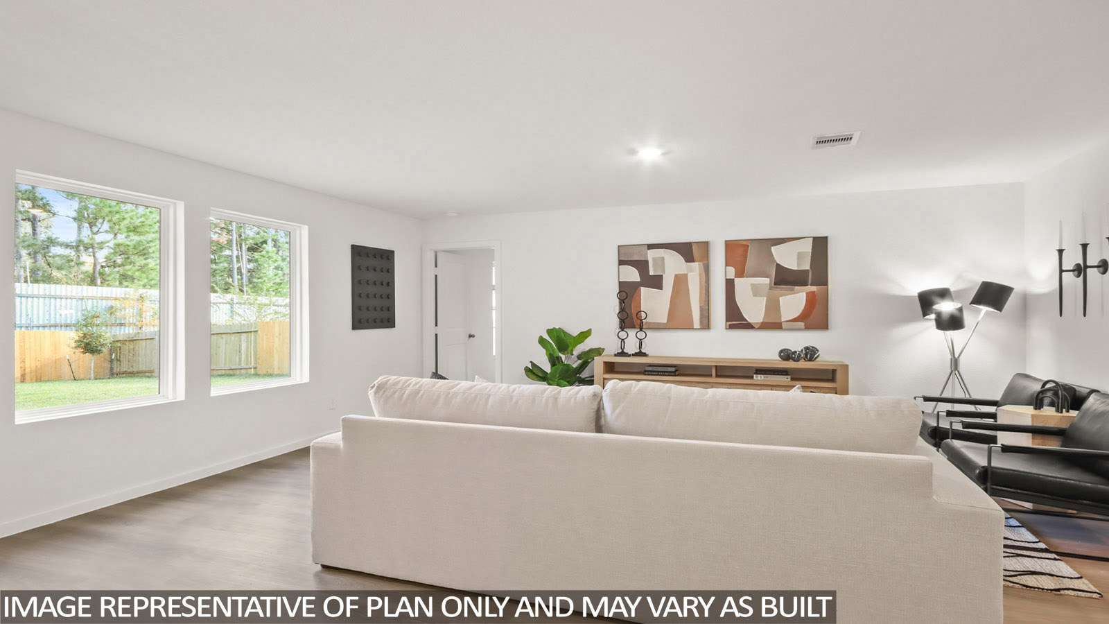 Austin living room with vinyl plank flooring and view of back yard and primary bedroom.