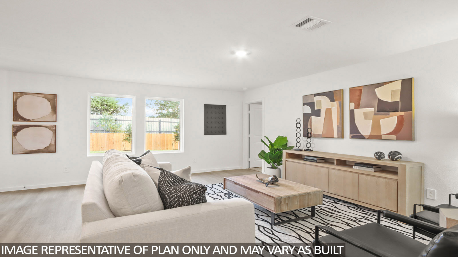 Austin living room with vinyl plank flooring and view of back yard and primary bedroom.