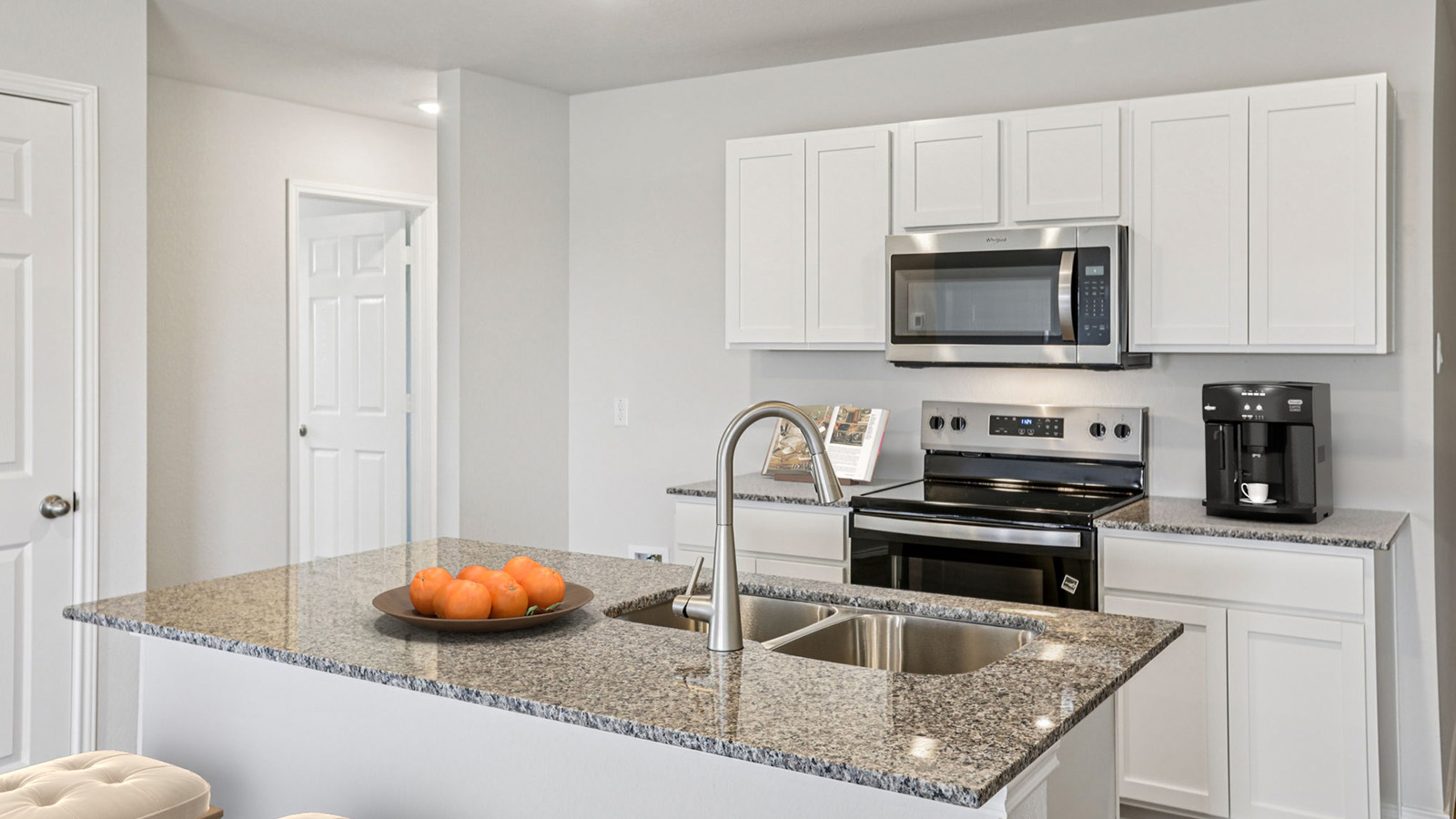 China Cottages kitchen with light cabinets and light countertops.