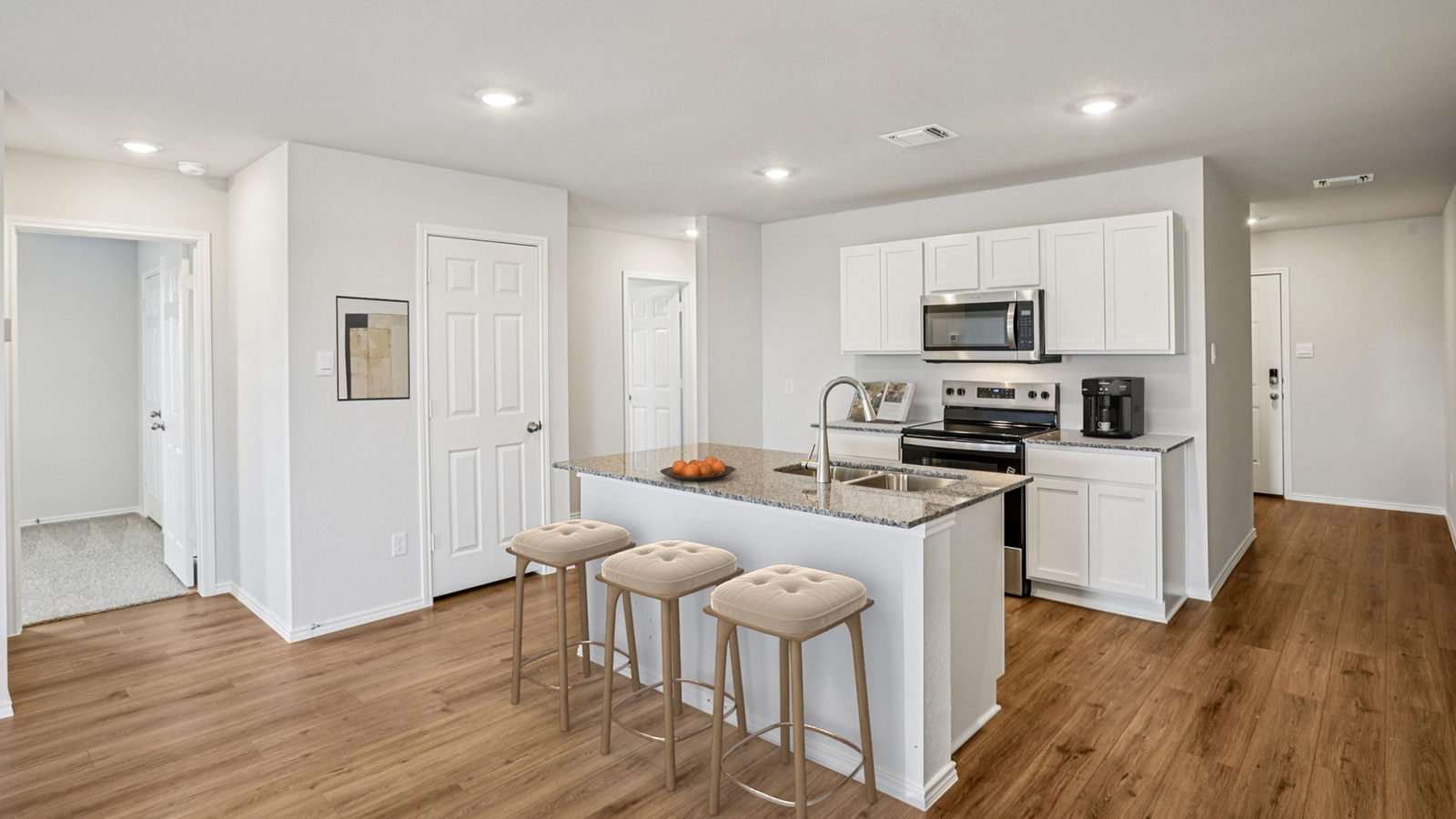 China Cottages kitchen with kitchen island and light cabinets and countertops.