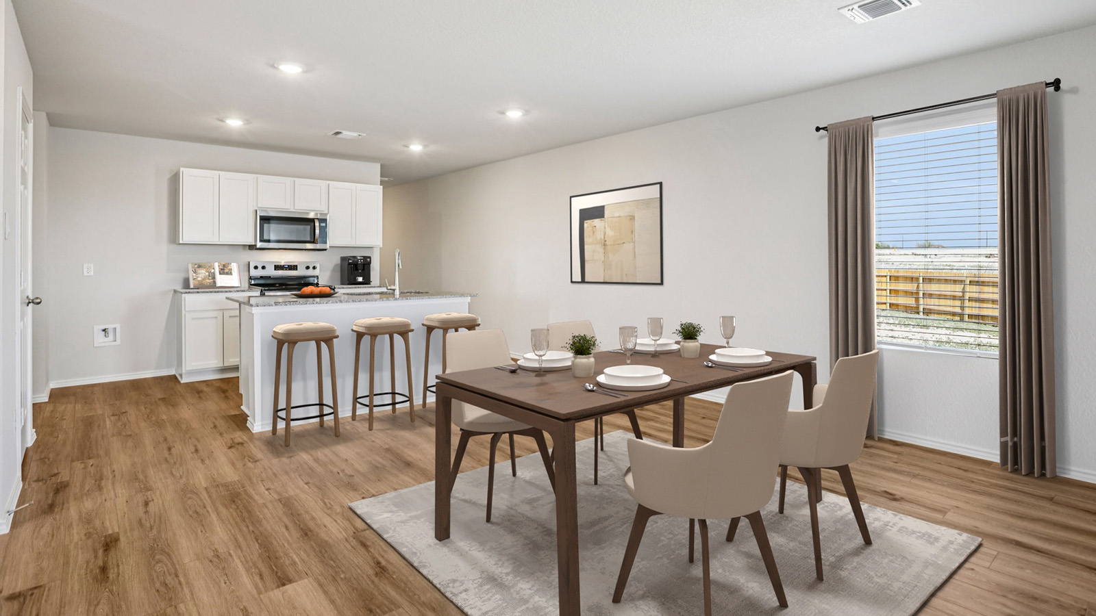 China Cottages dining room with view of kitchen with kitchen island and light cabinets.