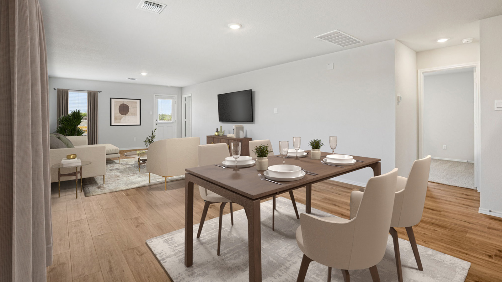 China Cottages dining room with view of living room with windows for natural lighting.