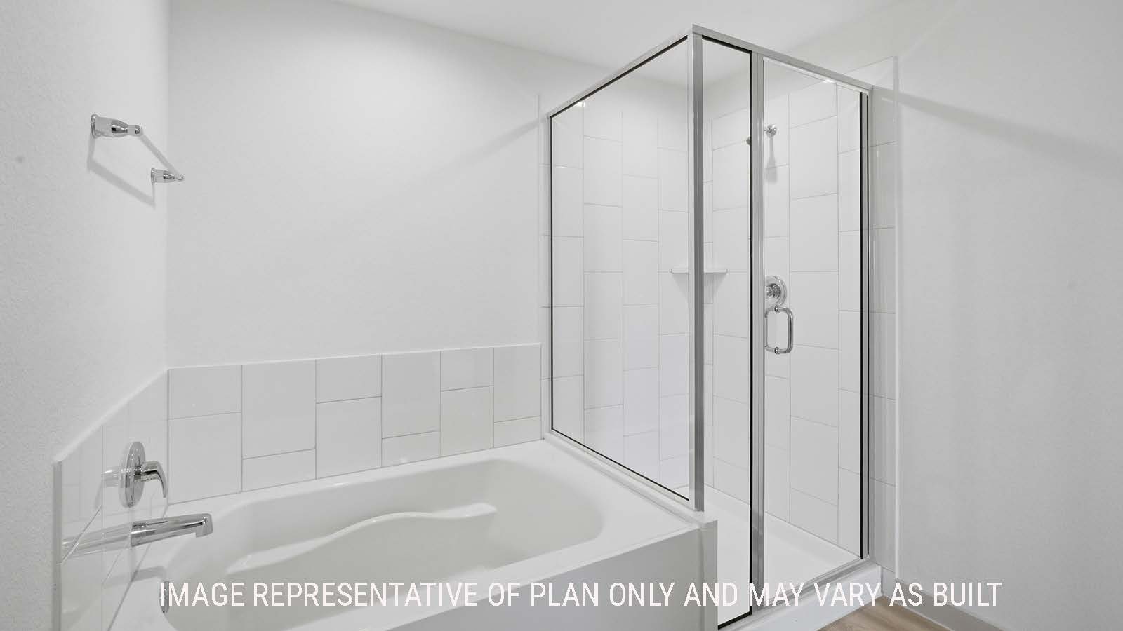 Kingston primary bathroom with double vanity sink and view of primary bedroom walk-in closet.