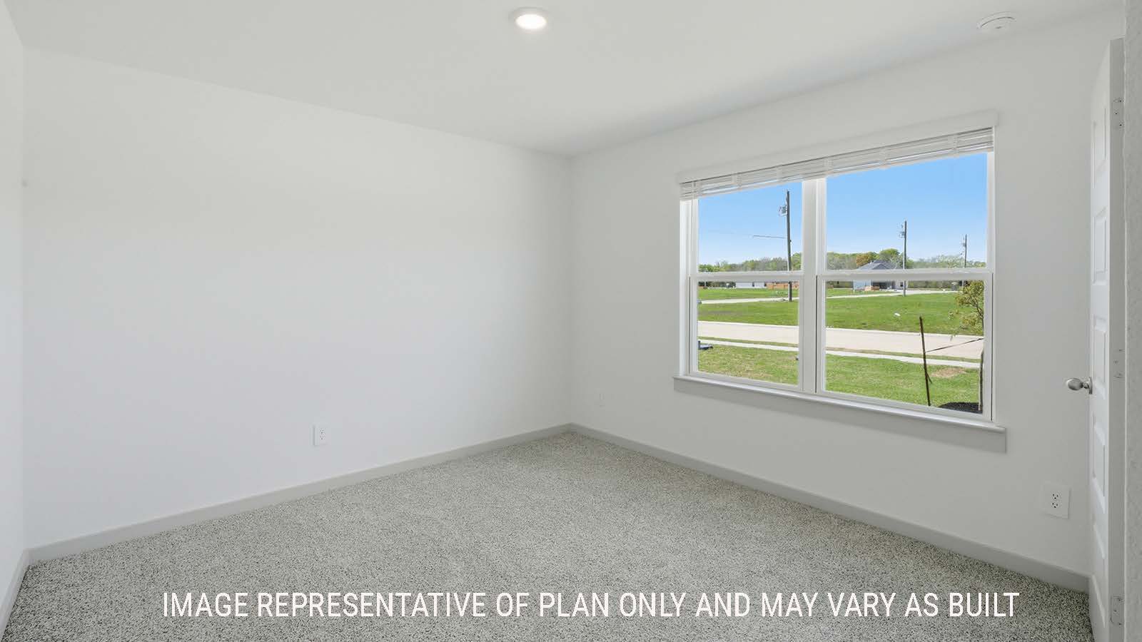 Kingston secondary bedroom with carpeted flooring and view of open concept kitchen.