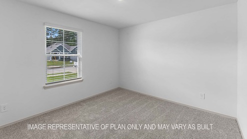 Cali secondary bedrrom with carpet flooring and window with view of outside.