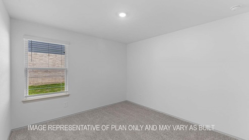 Cali secondary bedrrom with carpet flooring and window with view of outside.