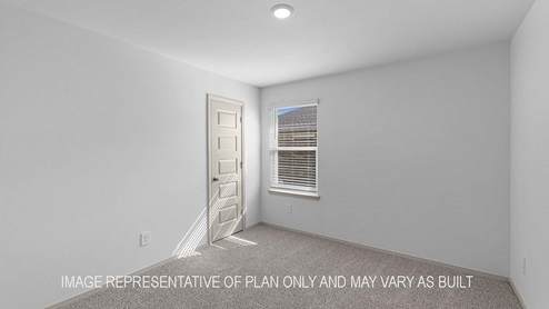 Cali secondary bedrrom with carpet flooring and window with view of outside.