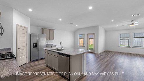 Cali kitchen island with light cabinets and granite countertops.