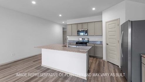 Cali kitchen island with light cabinets and granite countertops.