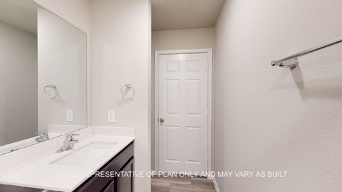 Kingston secondary bathroom with single vanity and mirror.