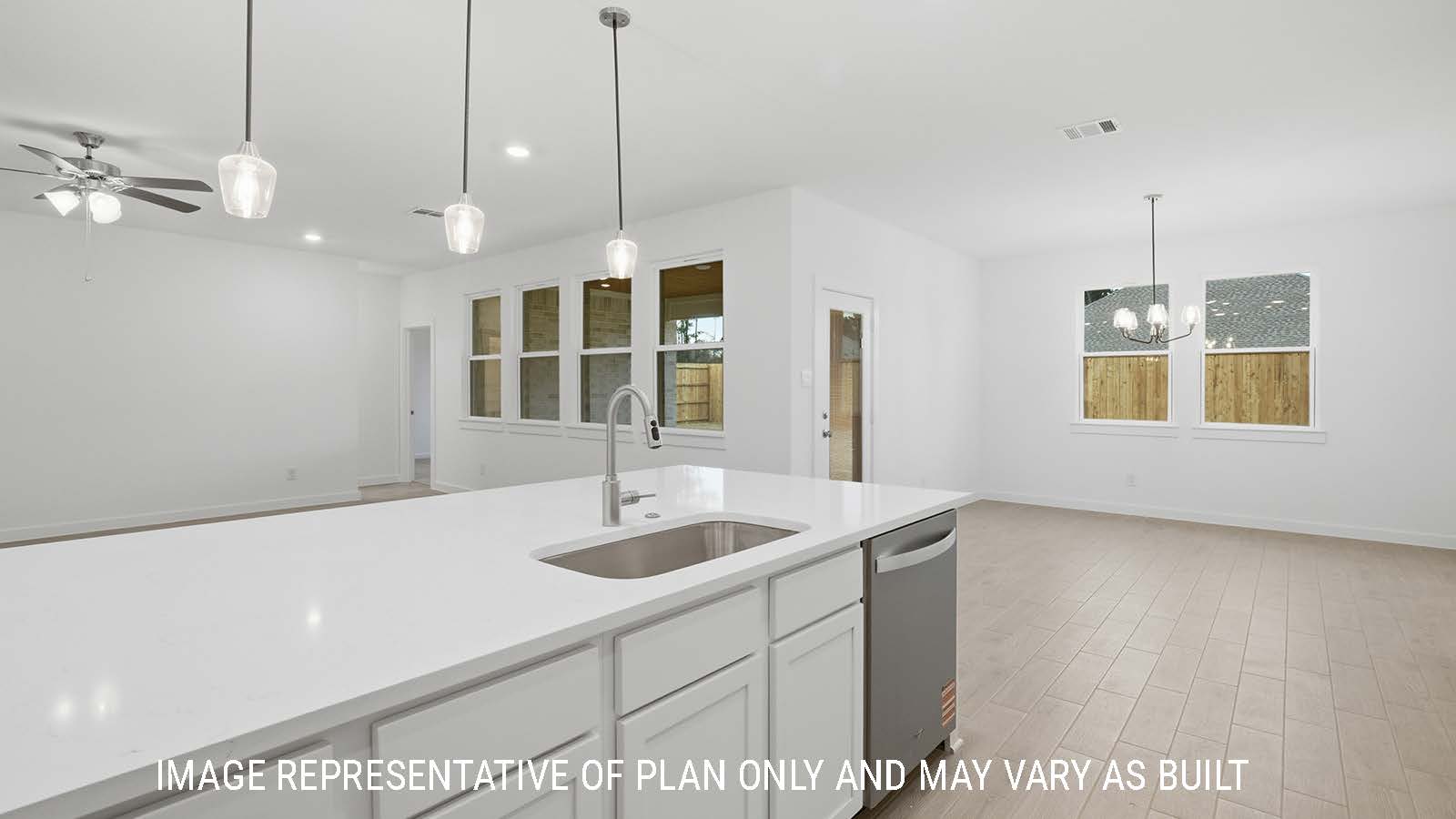Berkshire kitchen with white cabinets and white countertops and view of open concept dining room.