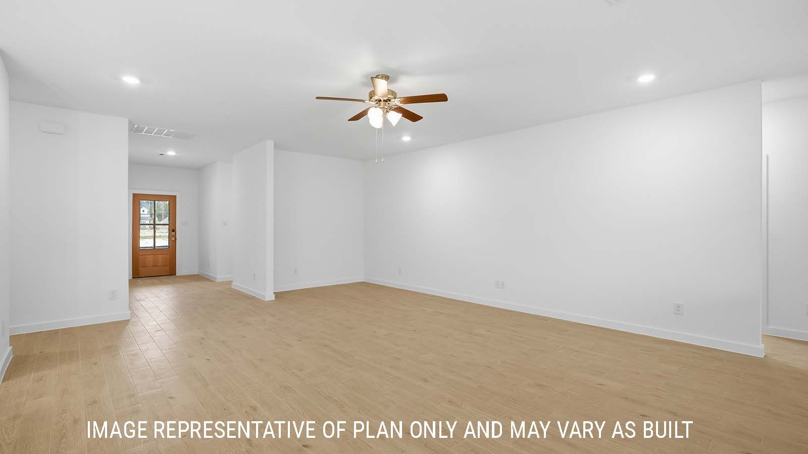 Berkshire living room with windows for natural lighting and view of backyard and view of open concept kitchen and dining room.