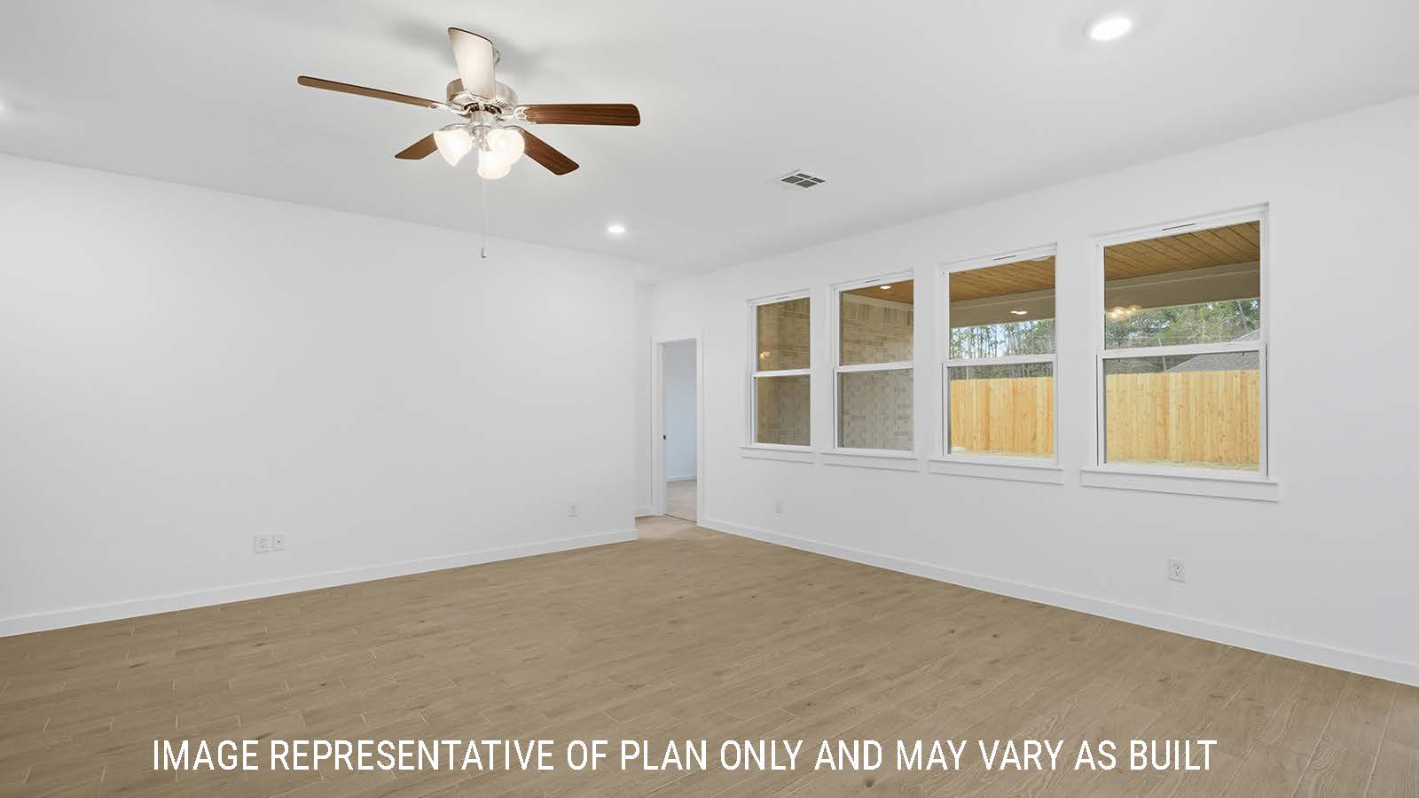 Berkshire living room with windows for natural lighting and view of backyard and view of primary bedroom.