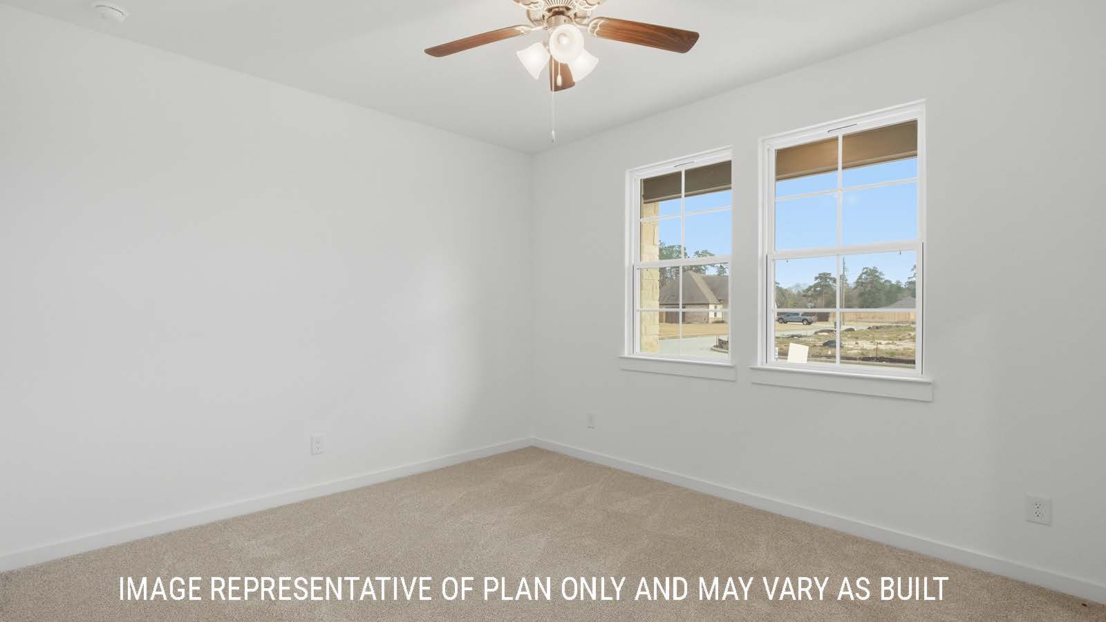 Berkshire primary bedroom with carpeted flooring and windows for natural lighting.