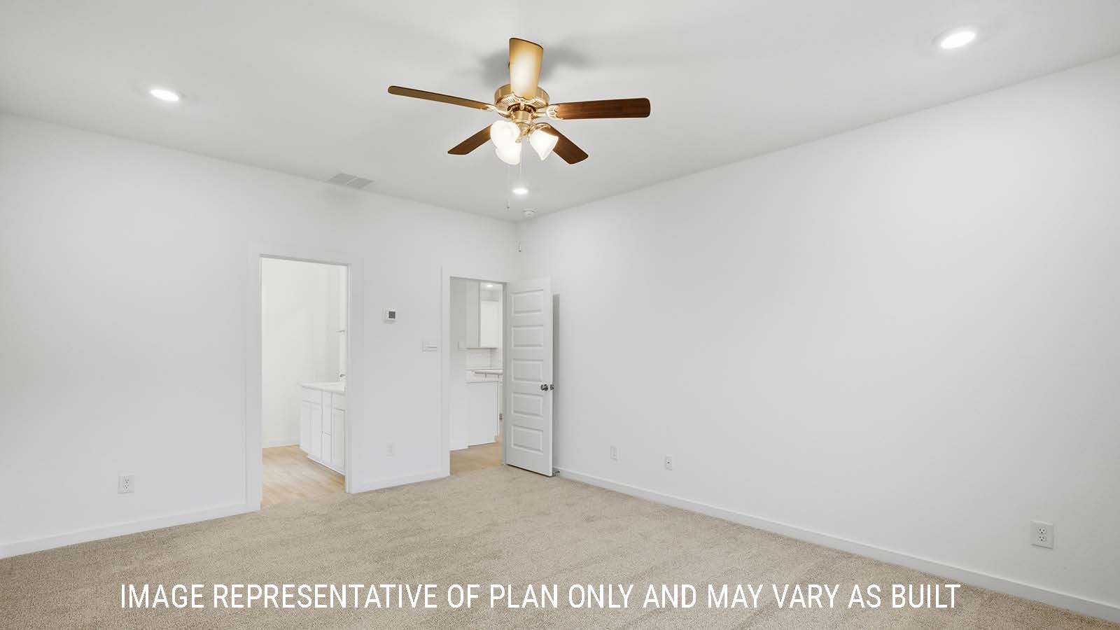 Berkshire primary bedroom with carpeted flooring and view of primary bathroom.