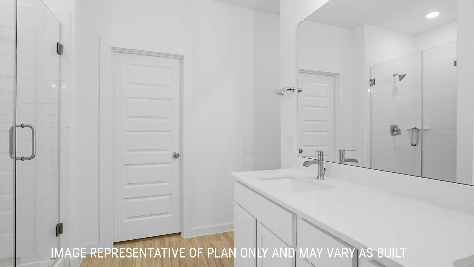 Berkshire primary bathroom with vanity sink with white countertops and walk-in shower.