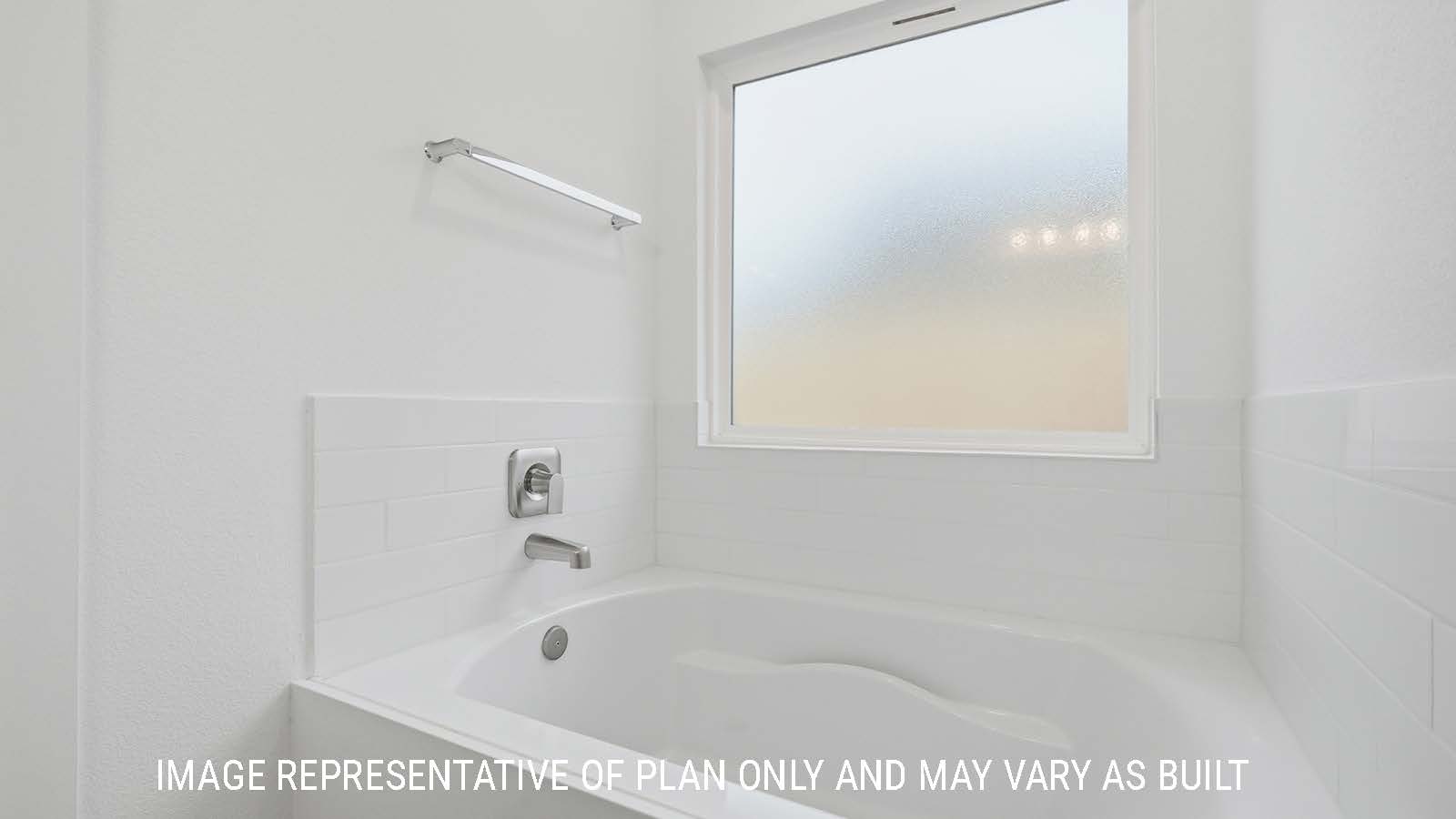 Berkshire primary bathroom with garden tub and view of private window for natural lighting.