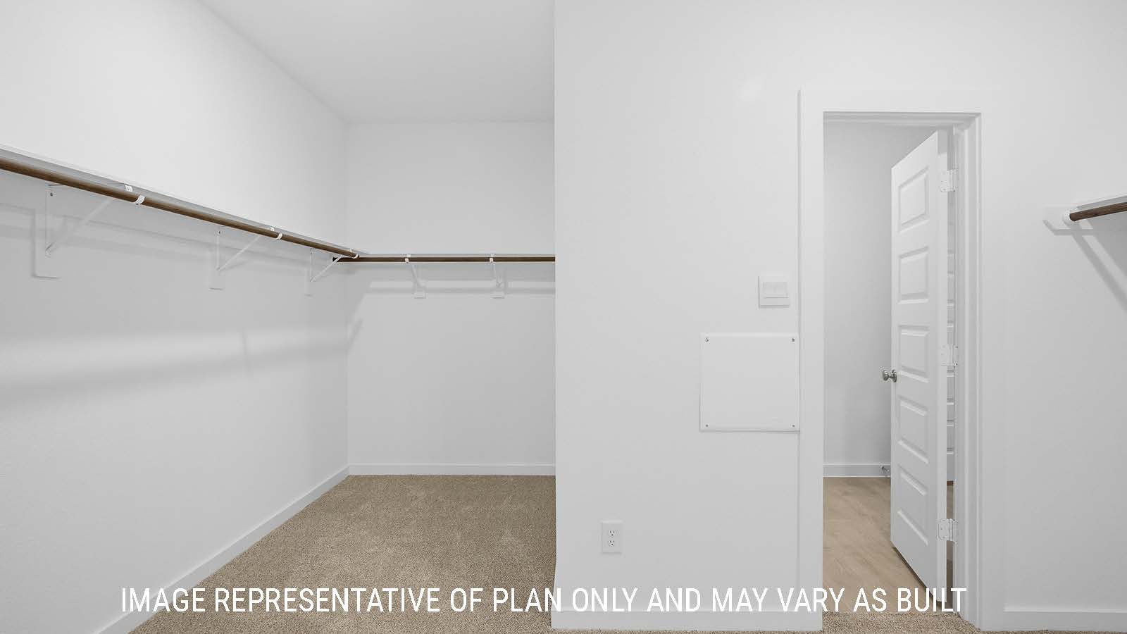 Berkshire primary bedroom closet with carpeted flooring and shelving for storage.