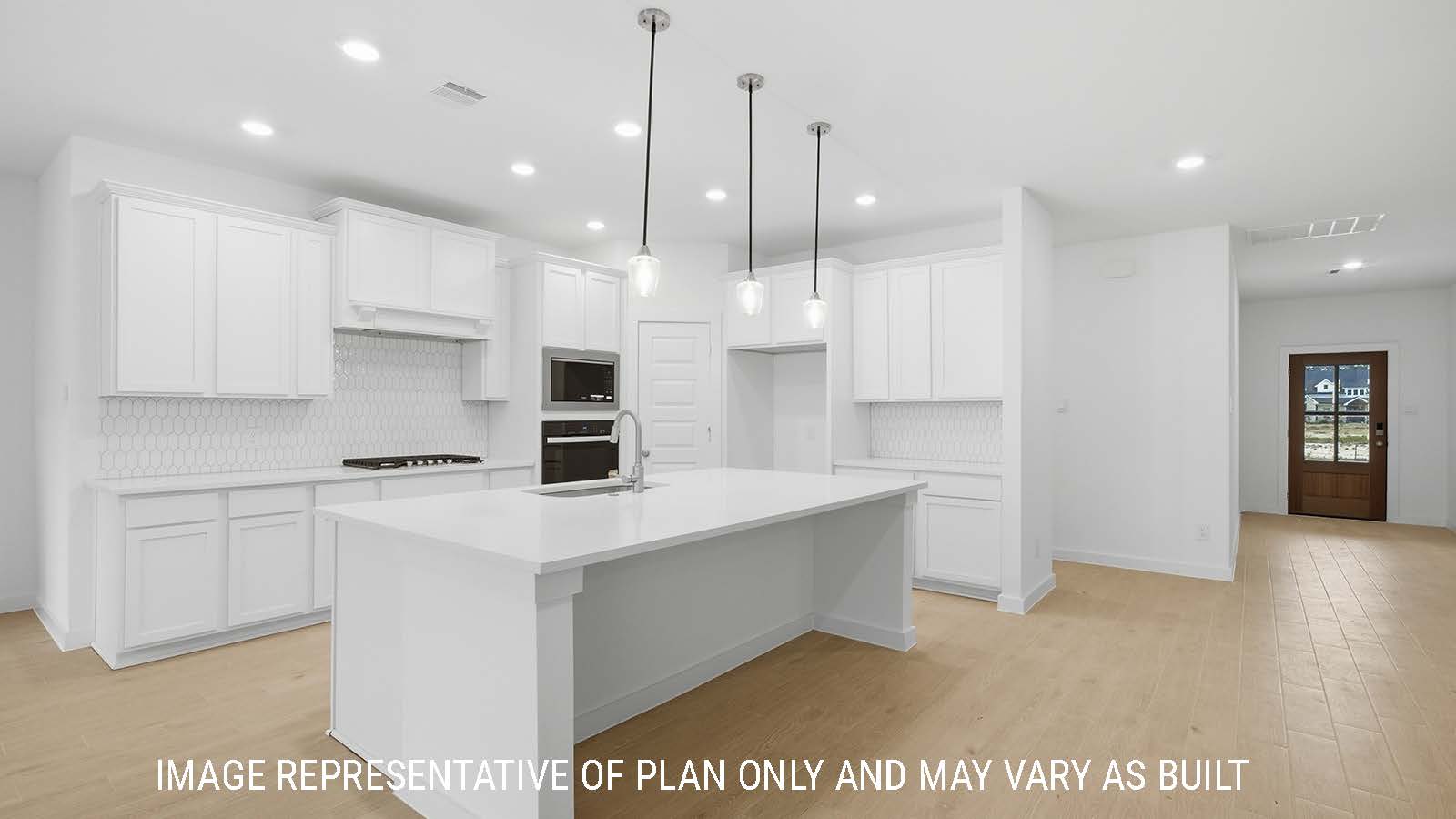 Berkshire kitchen with kitchen island with white cabinets and view of front entry way.
