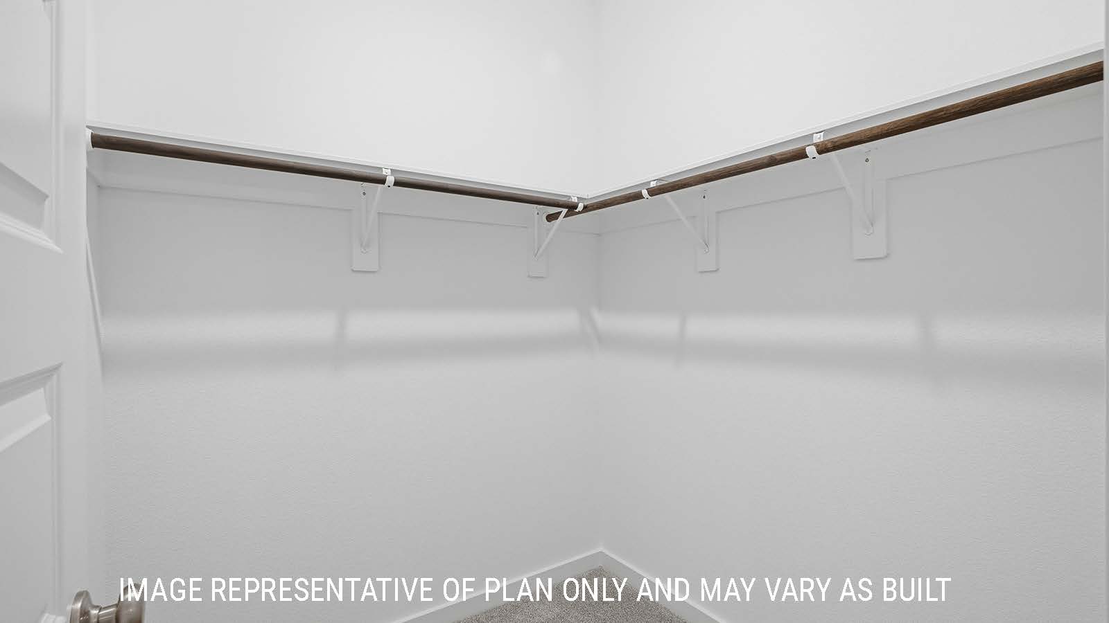 Berkshire primary bedroom closet with carpeted flooring and shelving for storage.