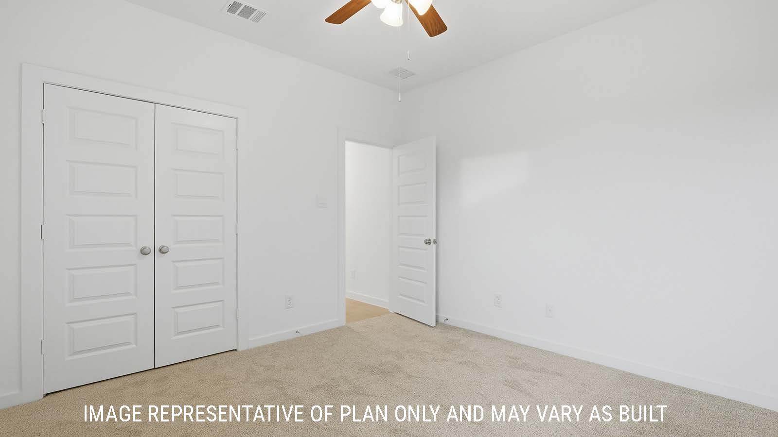 Berkshire secondary bedroom with carpeted flooring and view of closet and hallway.