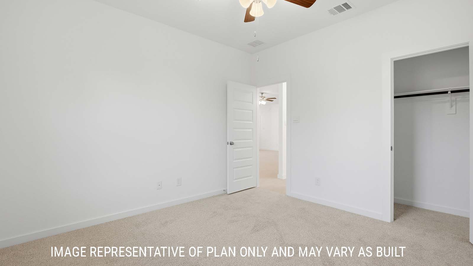 Berkshire secondary bedroom with carpeted flooring and view of closet and hallway.
