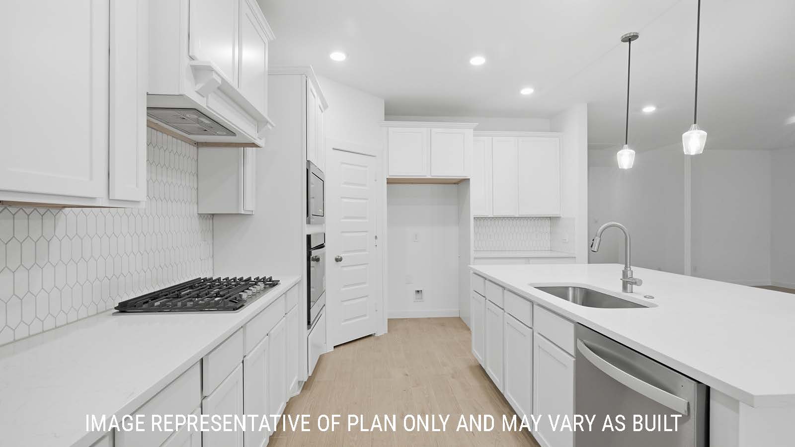 Berkshire kitchen with white cabinets and white countertops and view of front entry hallway.