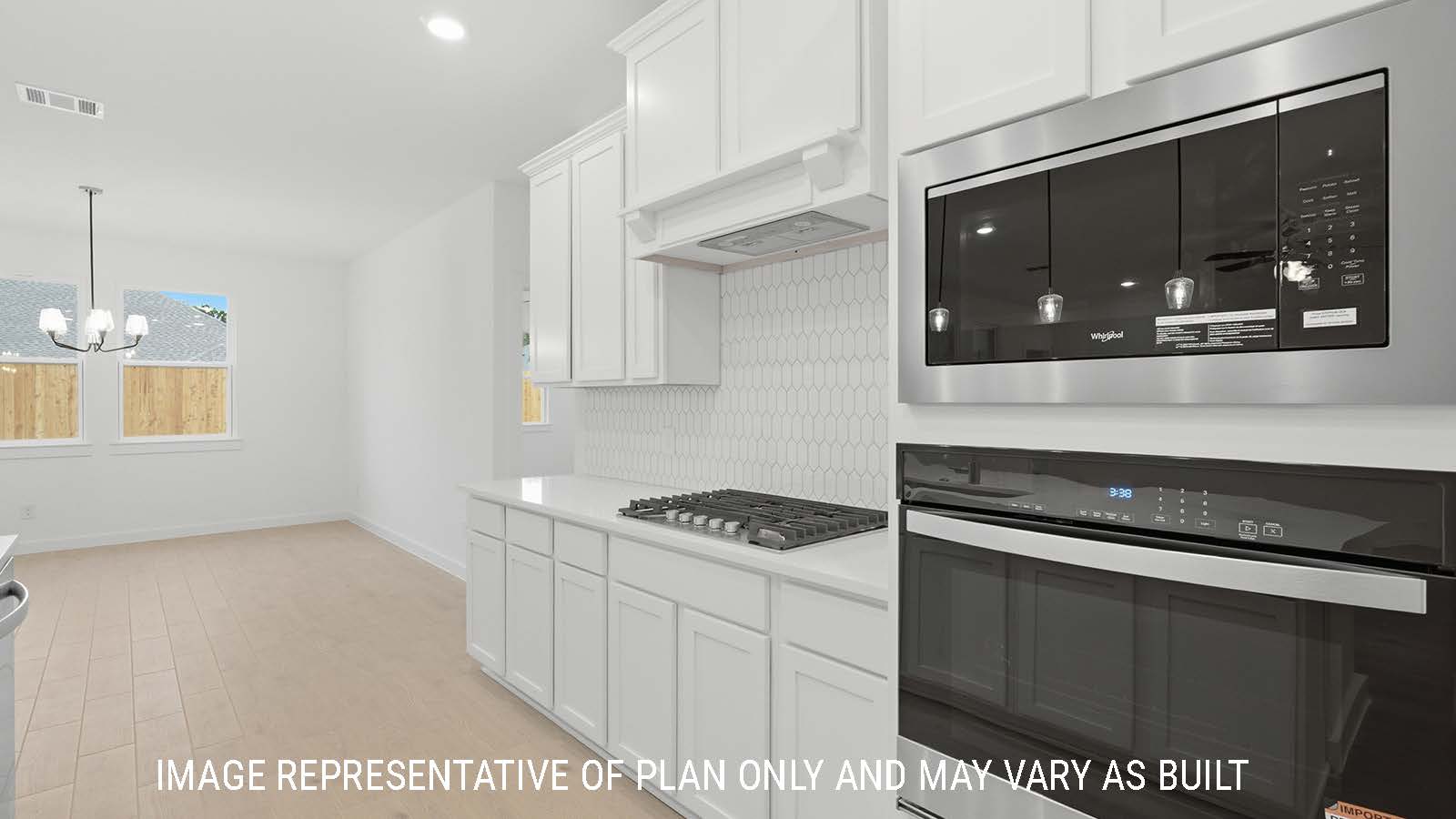 Berkshire kitchen with white cabinets and white countertops and view of open concept dining room.
