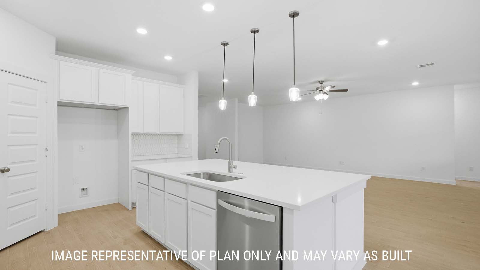 Berkshire kitchen with kitchen island with white countertops and view of open concept living room.