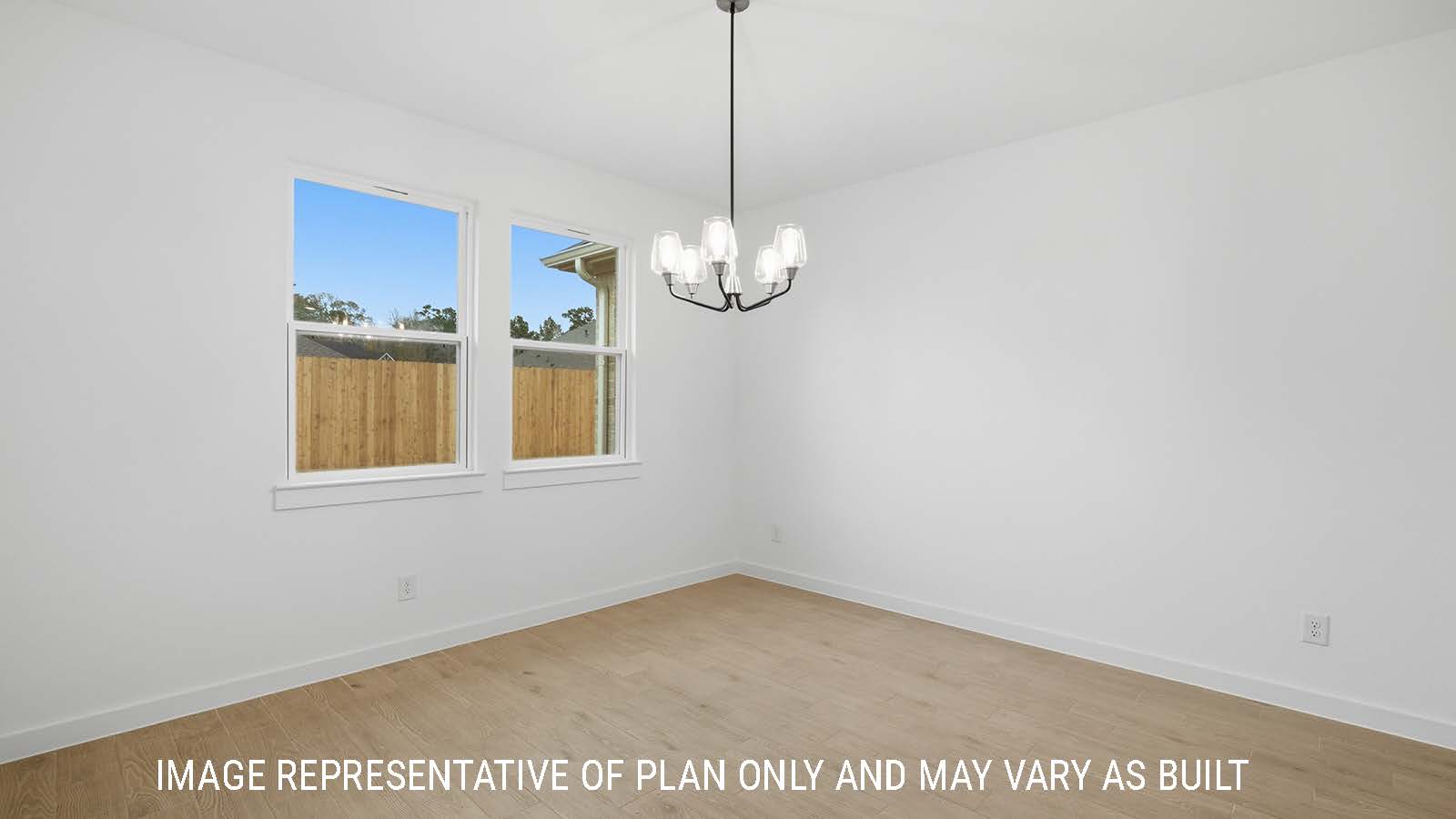 Berkshire dining room with windows for natural lighting and view of the backyard.