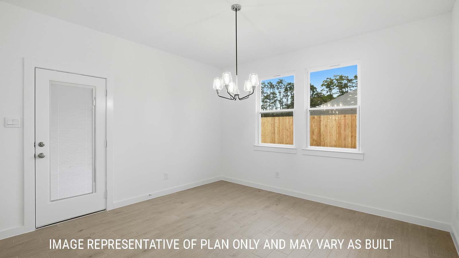 Berkshire dining room with windows for natural lighting and view of the backyard.