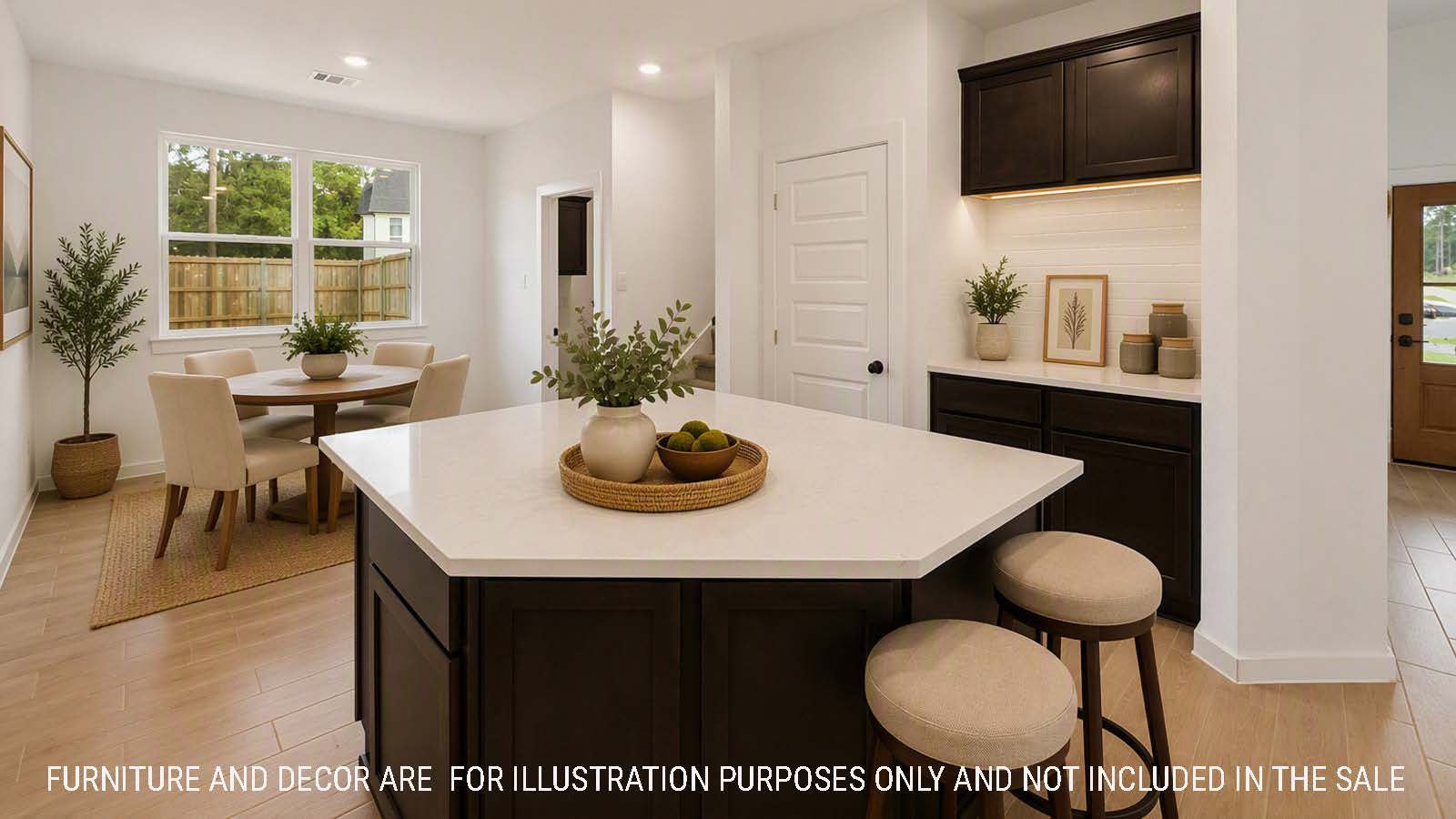 Newburgh kitchen with dark cabinets and white countertops and view of dining room.