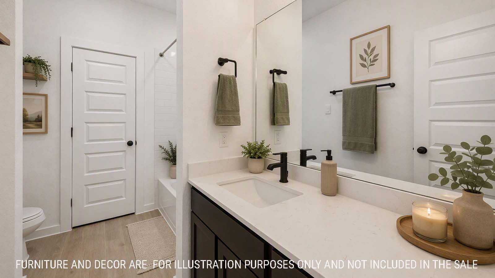 Newburgh primary bathroom with double vanity sink with dark cabinets and white countertops.