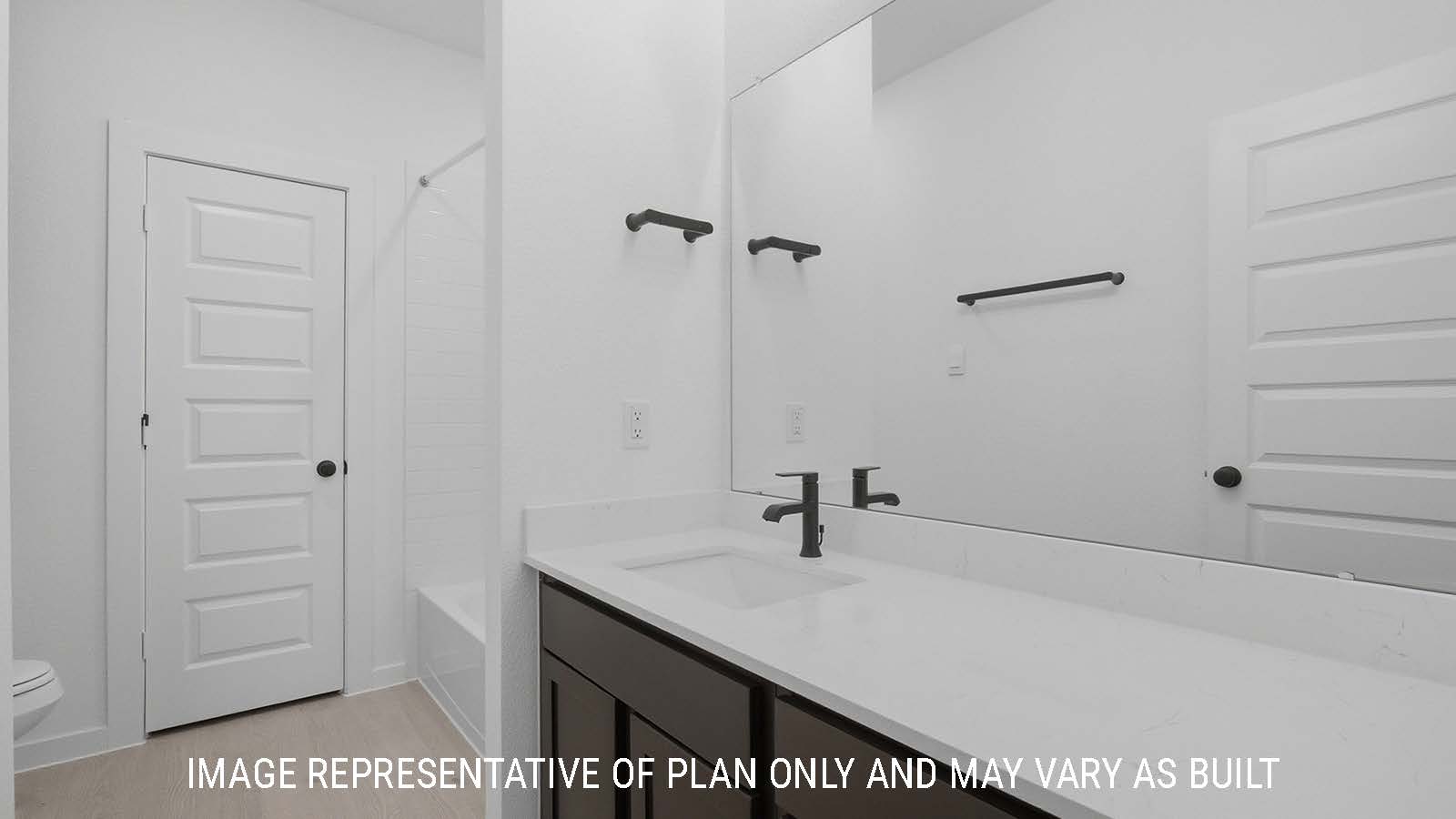 Newburgh secondary bathroom with vanity sink with white countertops and shower and tub combo.