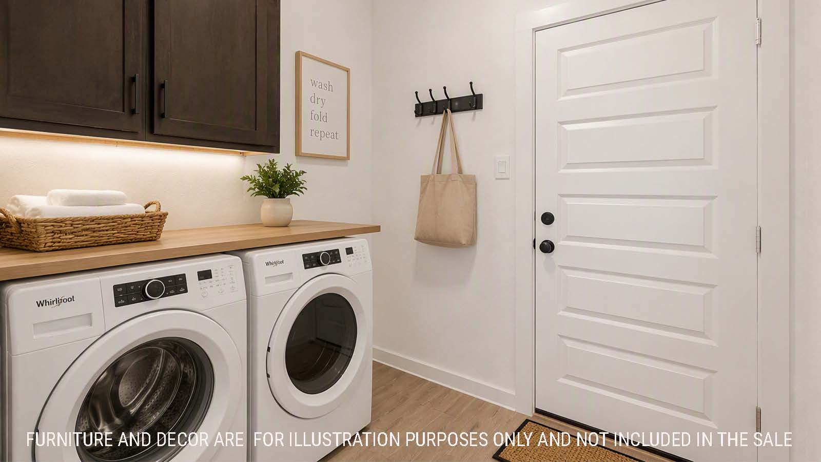 Newburgh utility room with washer and dryer and dark cabinets for storage.