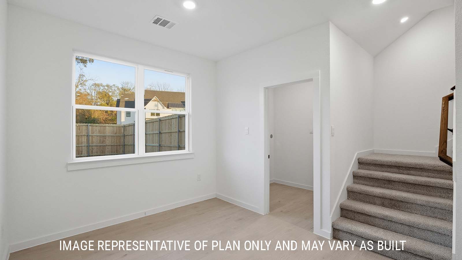 Newburgh dining room with windows for natural lighting and view of utility room and stairs.