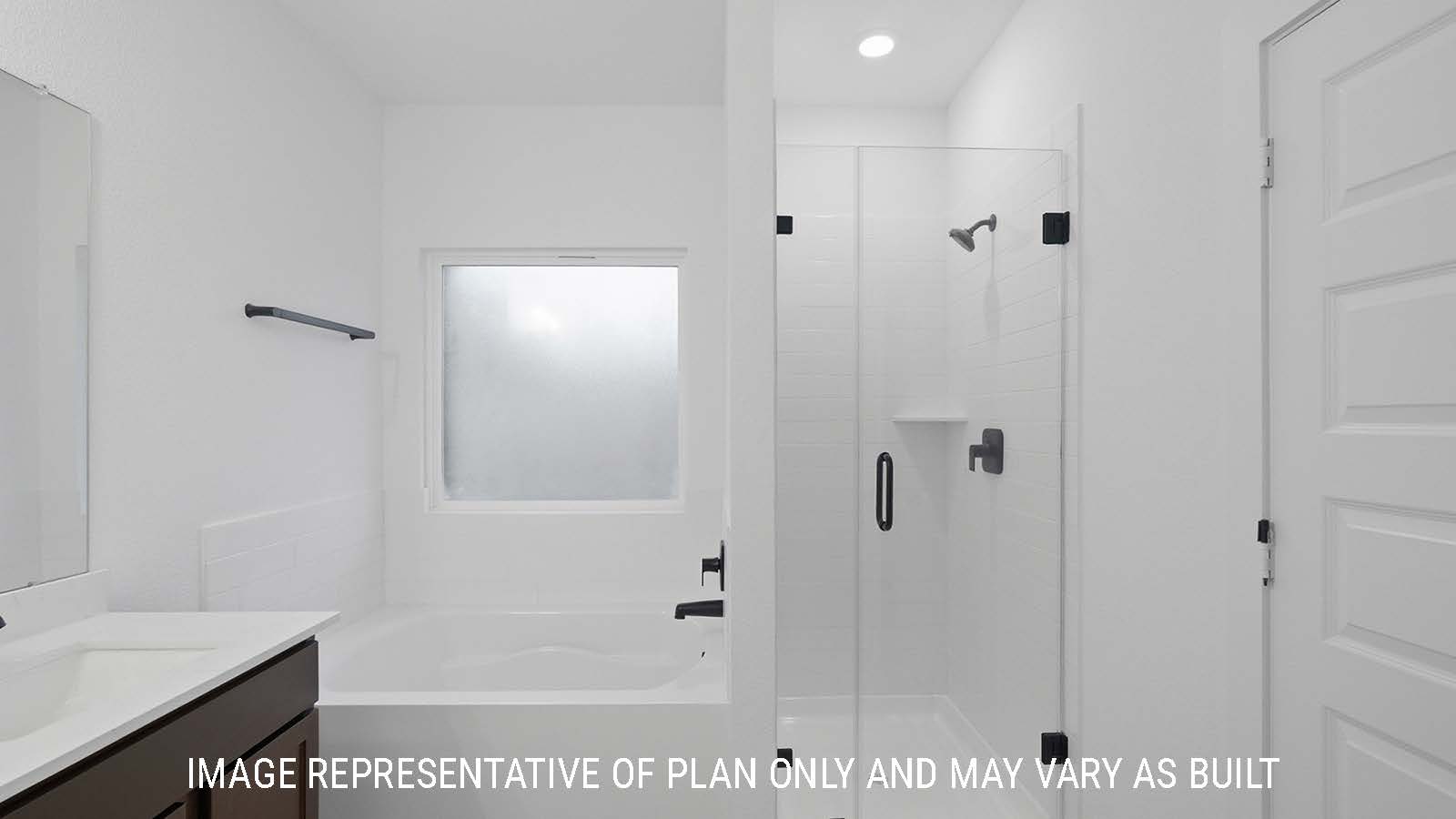 Newburgh primary bathroom with walk-in shower and garden tub.