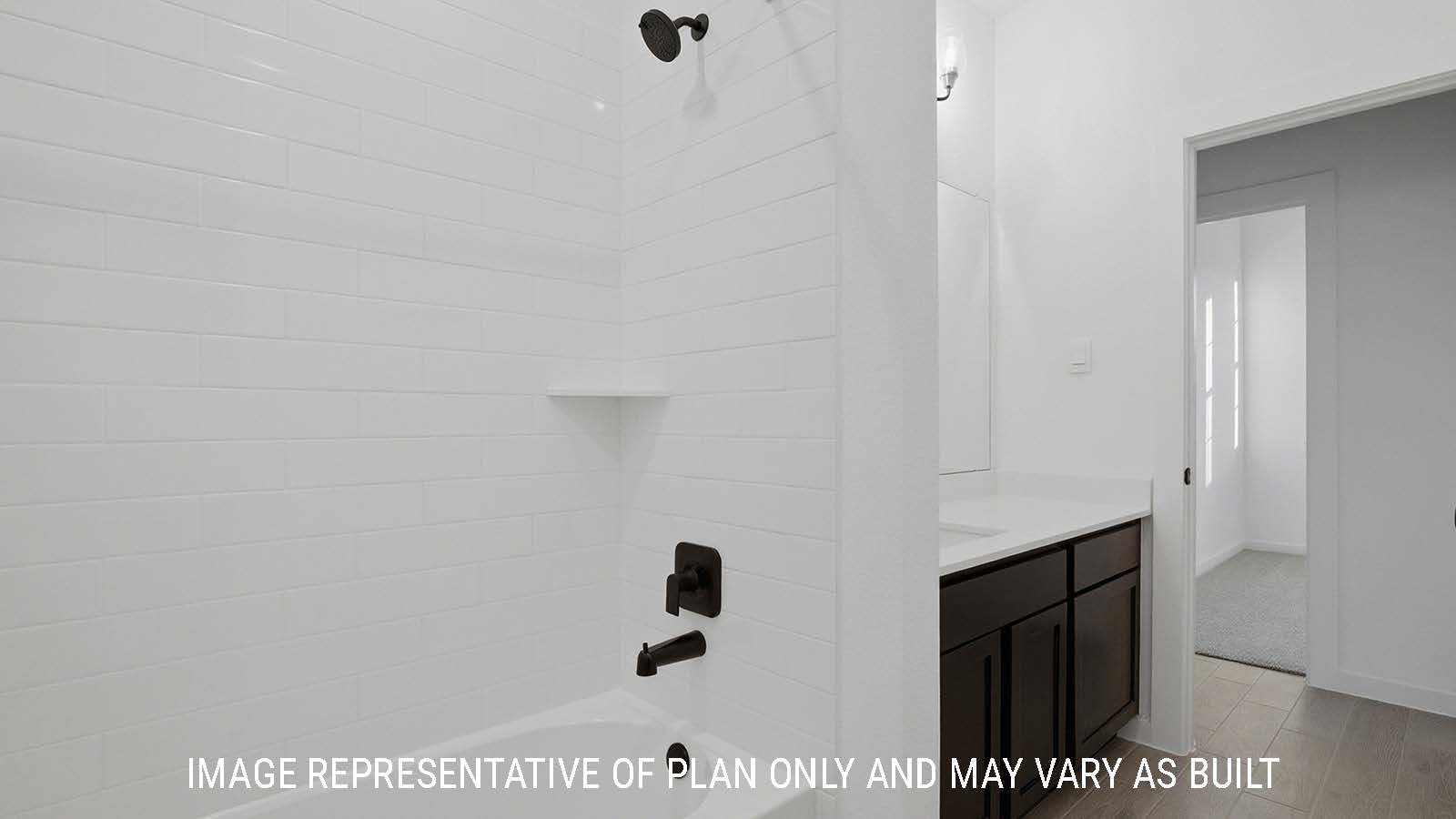 Newburgh secondary bathroom with vanity sink with white countertops and shower and tub combo.